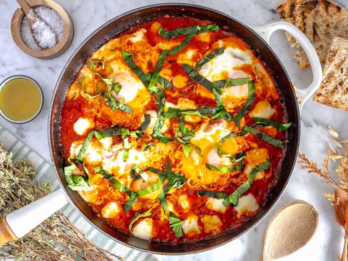 Eggs in purgatory with fresh basil, bread and oregano