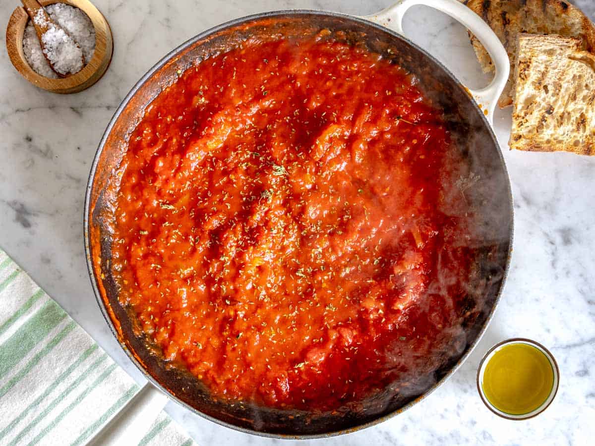 crushed san marzano tomatoes in a white skillet