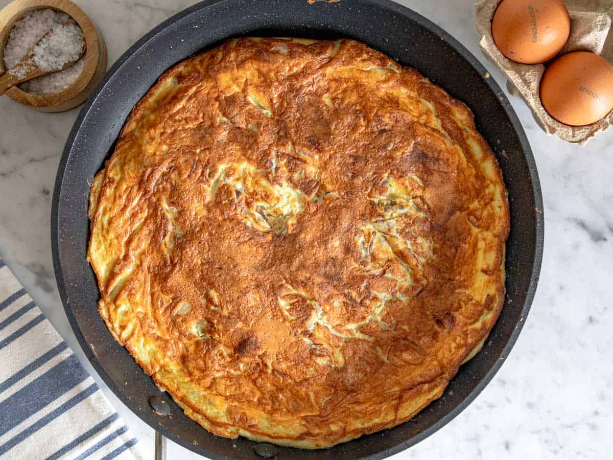 golden brown frittata cooked on a non-stick skillet