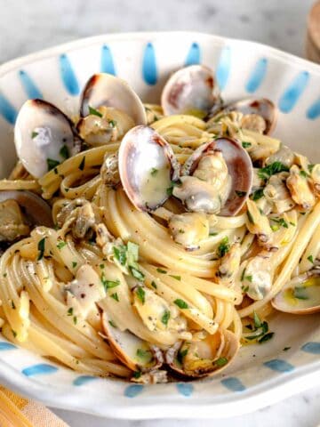 linguine with clam sauce in a blue plate