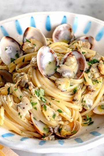 linguine with clam sauce in a blue plate