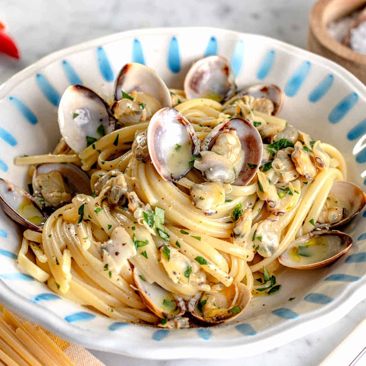 linguine with clam sauce in a blue plate