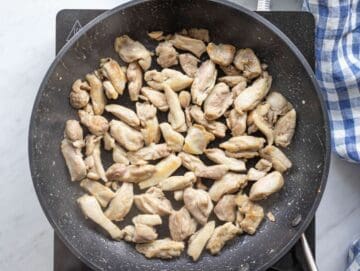 Step 2 cooking chicken sautéing seasoned chicken pieces until golden in a skillet.