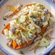 Fresh Chicken Waldorf Salad topping a sweet potato in a serving bowl for easy lunch or dinner.