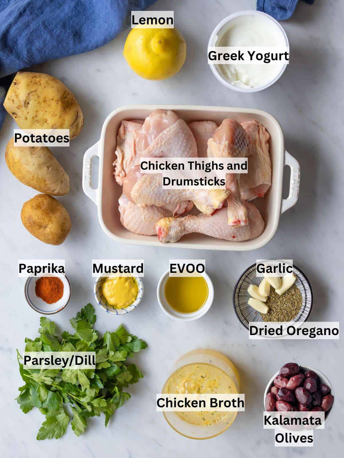 Ingredients for Easy Greek Lemon Chicken and Potatoes arranged on a table for cooking.