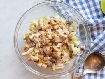 Step 2 Adding chicken apples grapes and celery to a mixing bowl.