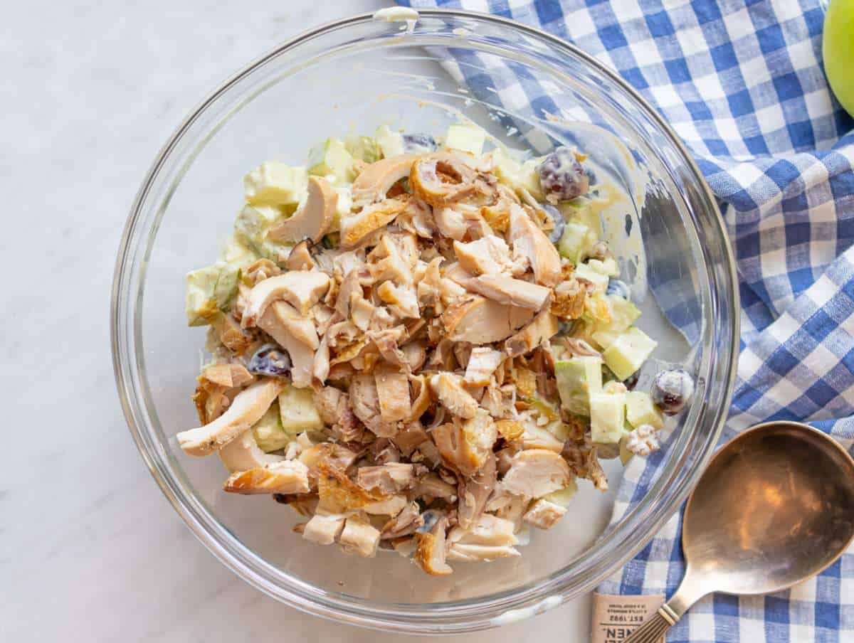Step 2 Adding chicken apples grapes and celery to a mixing bowl.