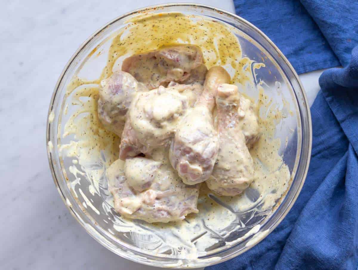 Step 2 Lemon yogurt coating whisked in a bowl for Greek Lemon Chicken.