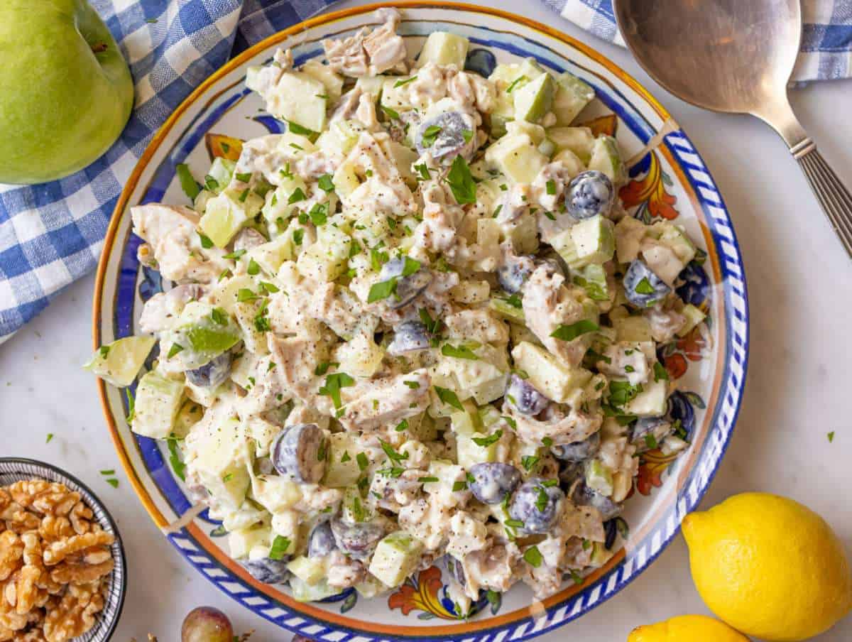 Step 3 tossing chicken waldorf salad with dressing and serving it on a platter.