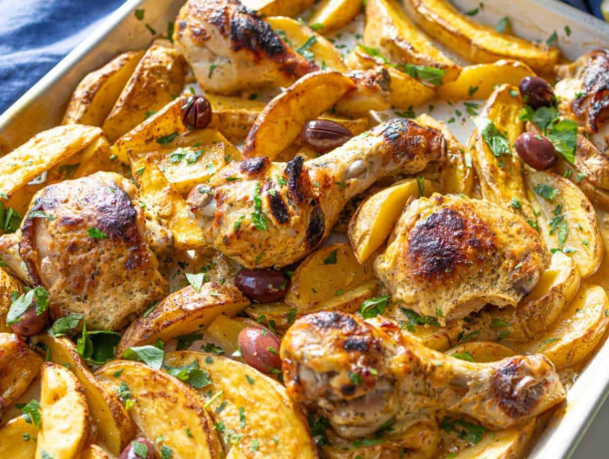 Step 4 Baked Greek Lemon Chicken and Potatoes golden and ready with fresh parsley and Kalamata olives.