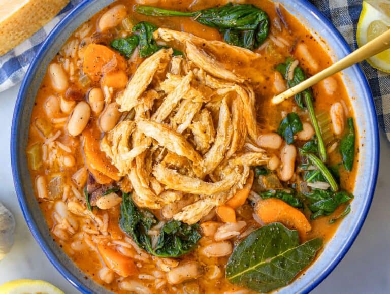 Step 5 Greek chicken and bean stew served in a bowl with shredded rotisserie chicken.