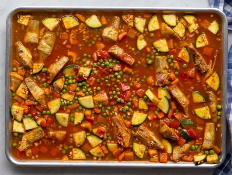 Step two pouring warm saffron broth over rice and vegetables.