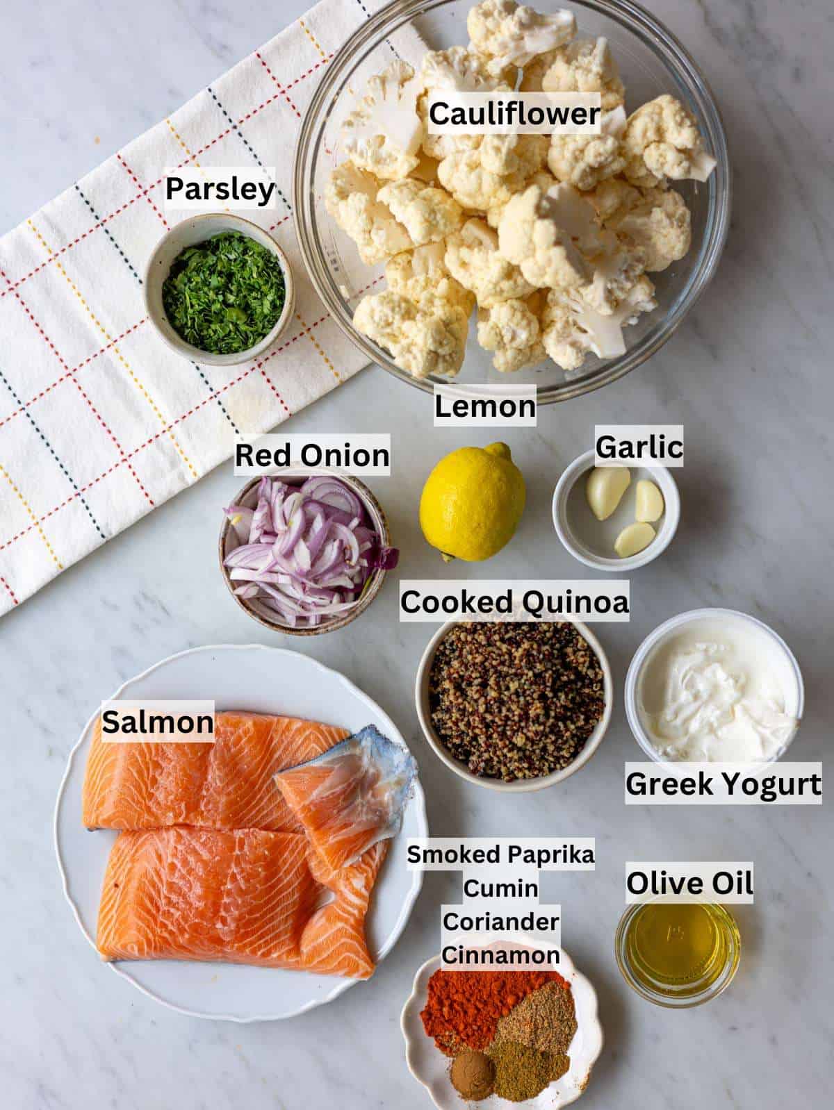 Ingredients for salmon quinoa bowl with cauliflower florets, salmon fillets, red onions, spices, quinoa, yogurt.