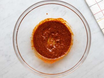 Step 1 Mixing olive oil, garlic, and shawarma spices in a bowl until smooth and fragrant.