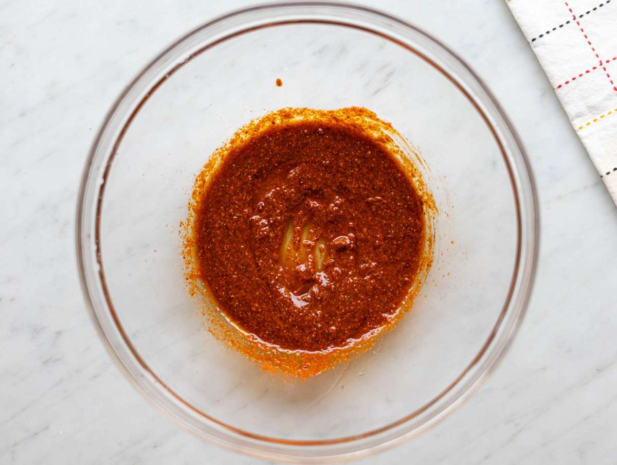 Step 1 Mixing olive oil, garlic, and shawarma spices in a bowl until smooth and fragrant.