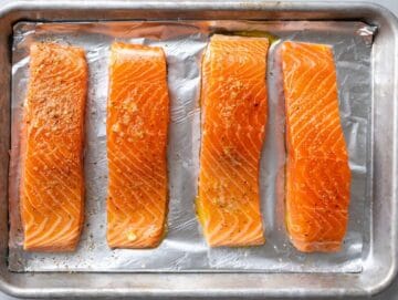 Step 1 Salmon fillets on a lined baking sheet brushed with olive oil, skin-side down.