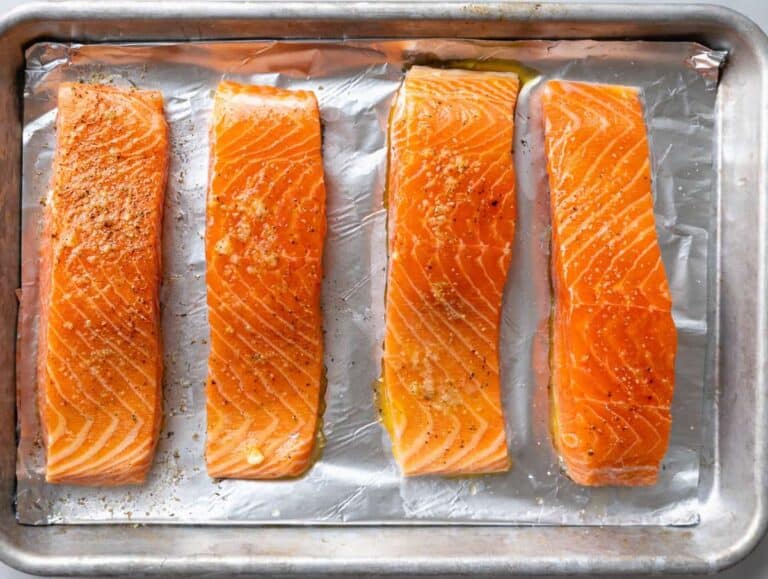Step 1 Salmon fillets on a lined baking sheet brushed with olive oil, skin-side down.