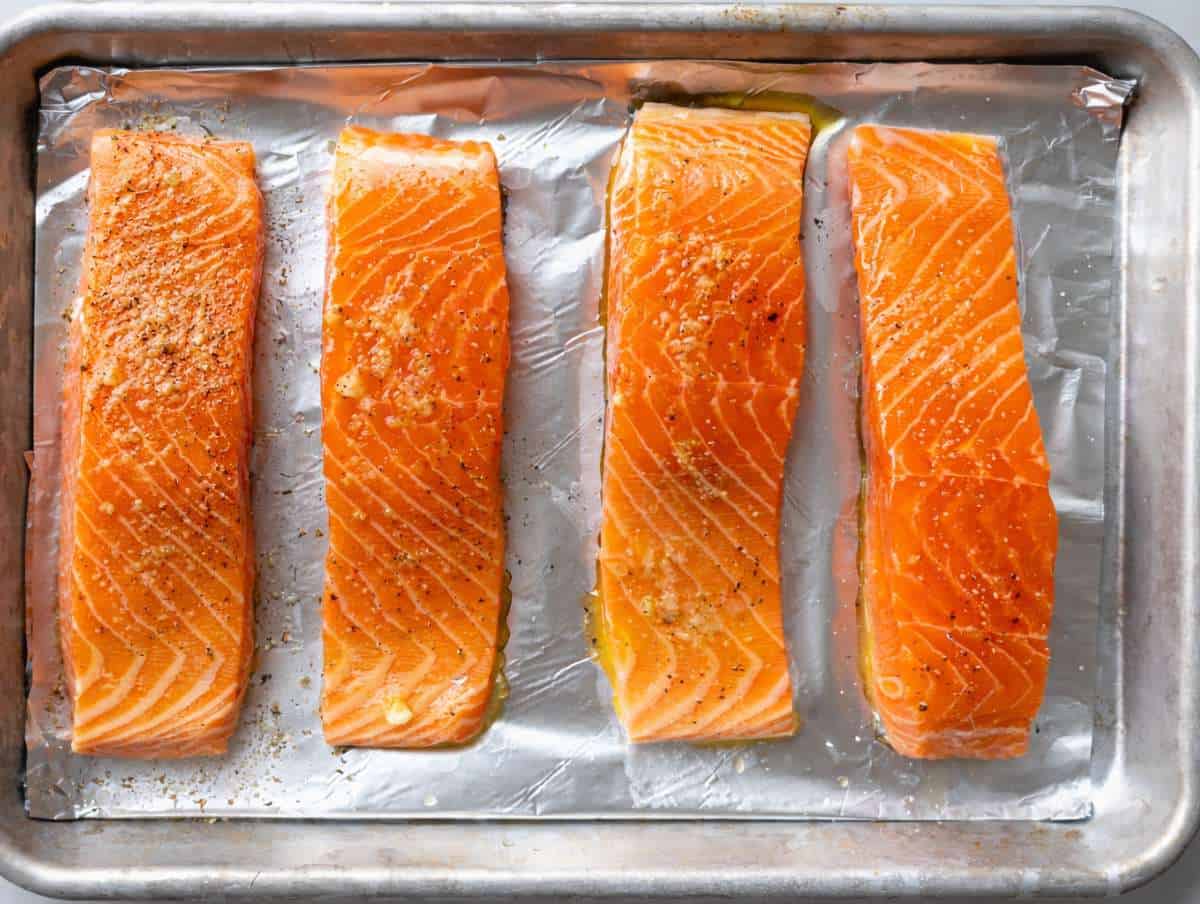 Step 1 Salmon fillets on a lined baking sheet brushed with olive oil, skin-side down.