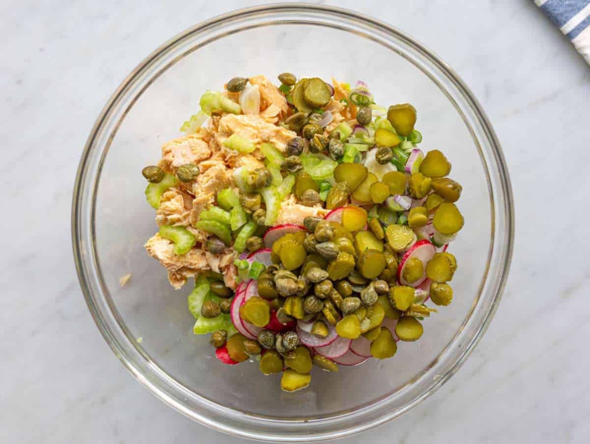Step 2 Chopped pickles radishes celery onion and capers mixed with flaked salmon a large bowl.