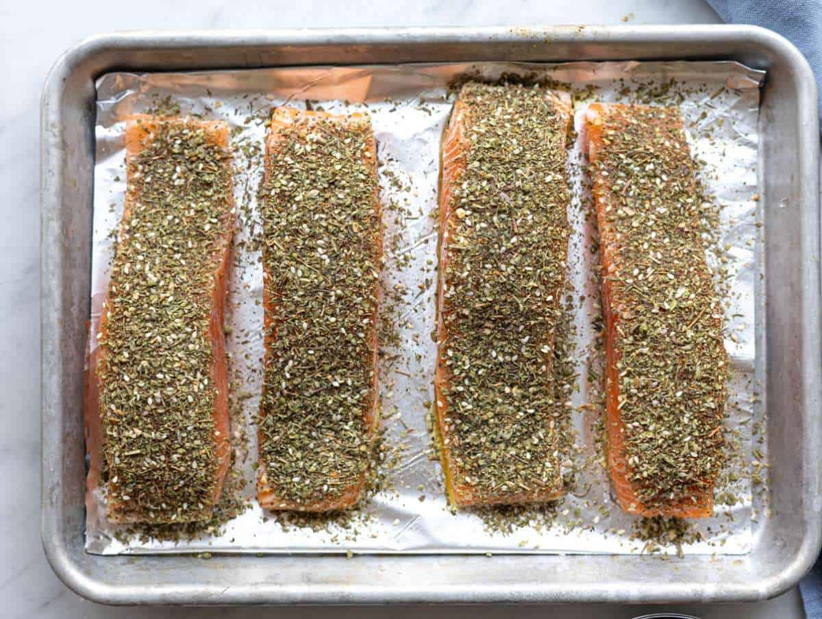 Step 2 Salmon seasoned with salt, pepper, garlic, and za’atar pressed gently into the surface.