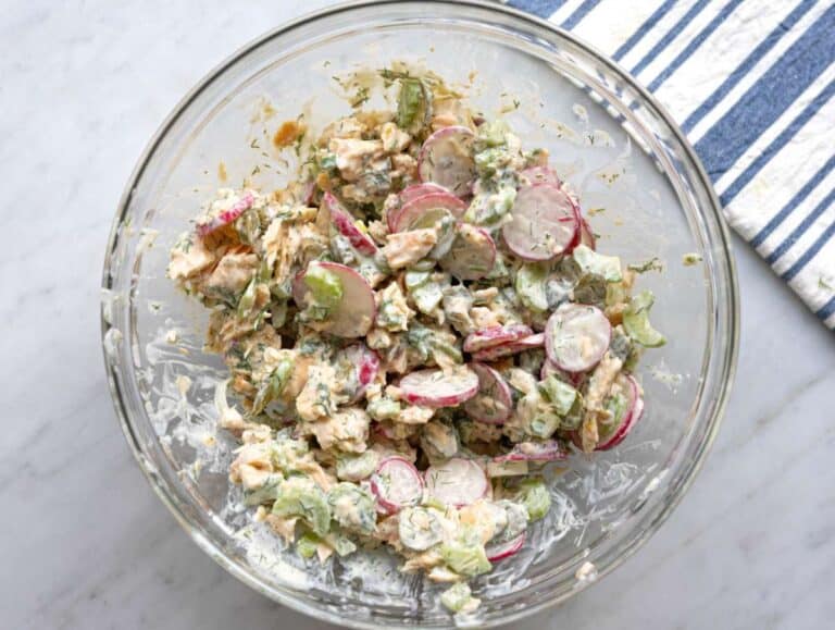 Step 3 Dressing poured over salmon and vegetables before mixing until creamy.