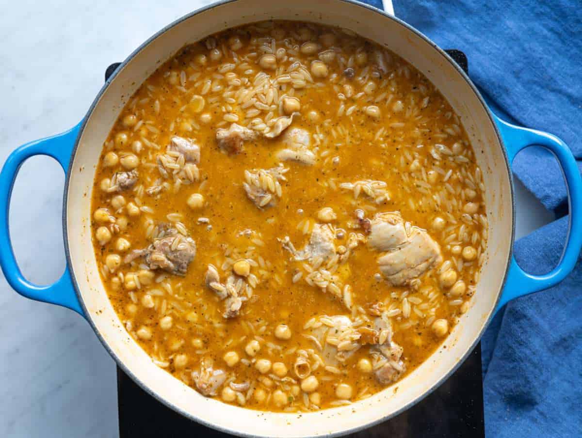 Step 3 Orzo simmering with broth chickpeas and chicken nestled back into the pan.