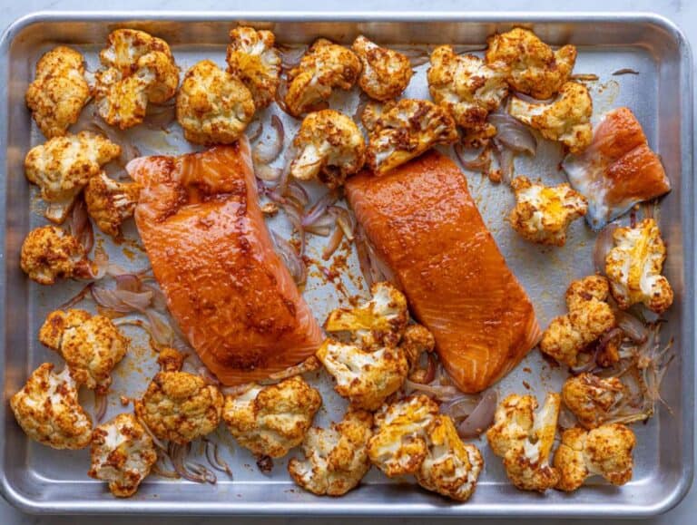Step 3 Salmon fillets added to roasted vegetables on sheet pan halfway through cooking.