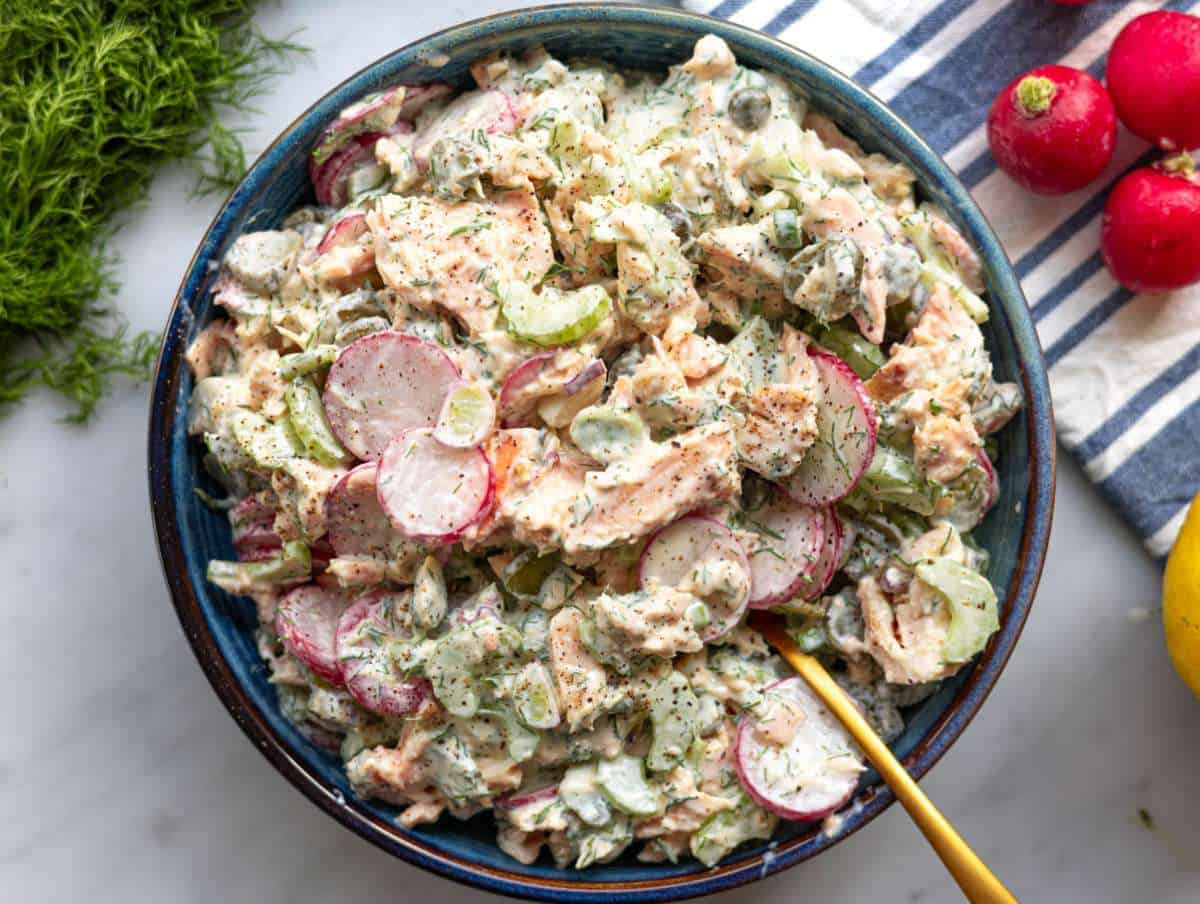 Step 4 Finished salmon salad served in a bowl with herbs on top.