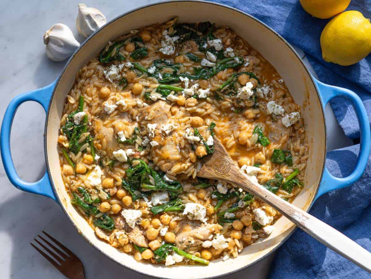 Step 4 One pan lemon chicken orzo with wilted spinach ready to serve topped with crumbled feta.