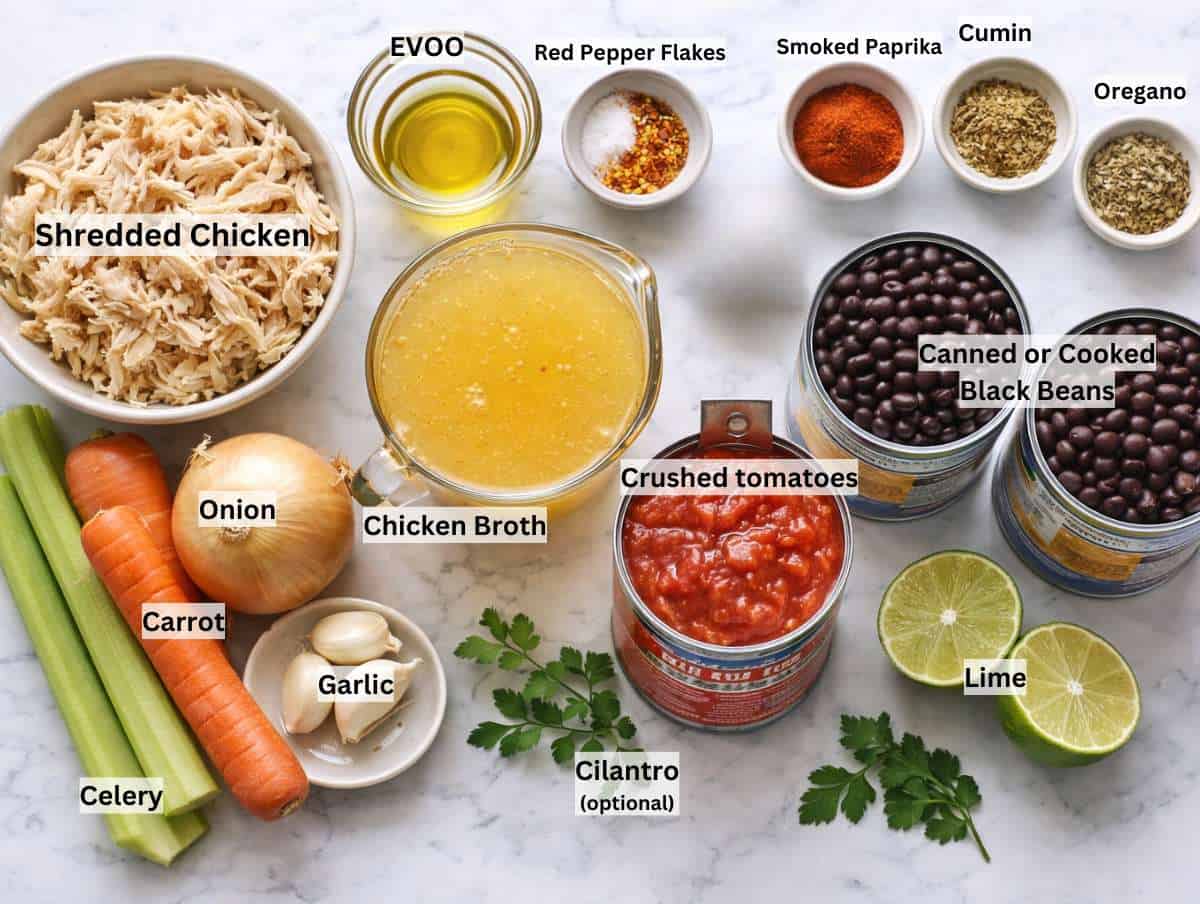 Ingredients for black bean chicken soup arranged on marble countertop.