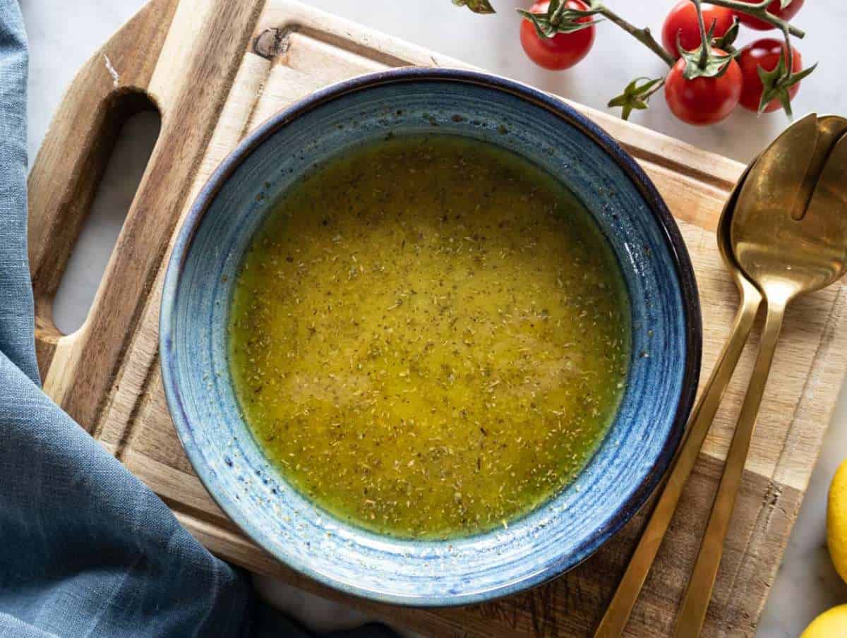 Lemon oregano dressing whisked in a bowl.
