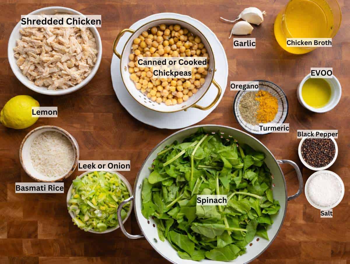 Shredded chicken, leek, spinach, rice, chickpeas, lemon, yogurt on wooden table.