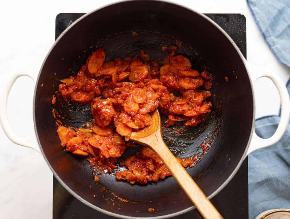 Step 1 Chopped onion, carrots, celery, garlic and tomato paste sautéing in olive oil in a large pot.