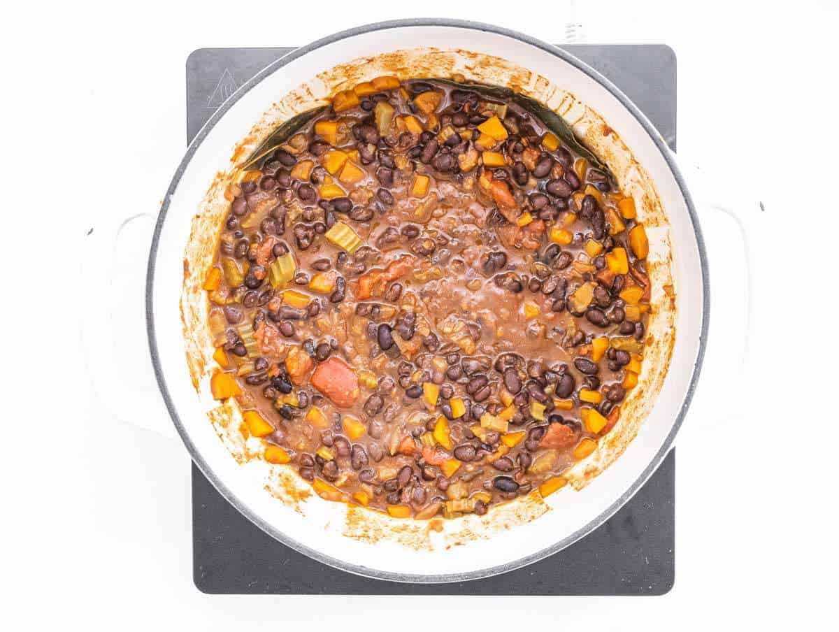 Step 2 Black beans tomatoes and broth simmering in large soup pot.