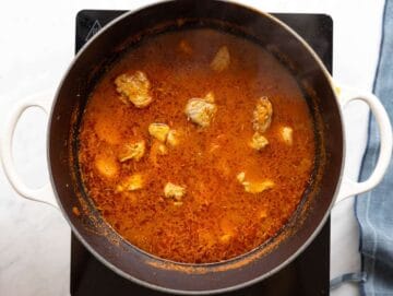 Step 2 Chicken added to boiling broth with herbs simmering gently.