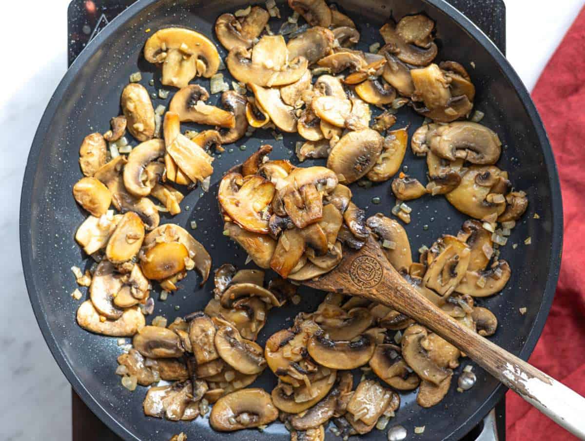 Step 2 Chopped onion and garlic cooking with mushrooms.