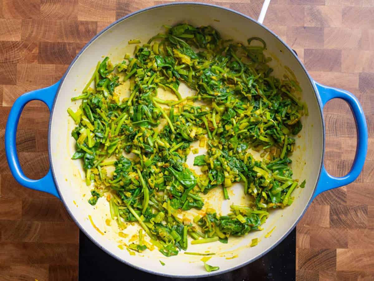 Step 2 Garlic, turmeric, and spinach wilting into fragrant leek mixture.
