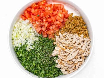 Step 2 Lentils, chopped herbs, tomatoes, and chicken added to bowl.