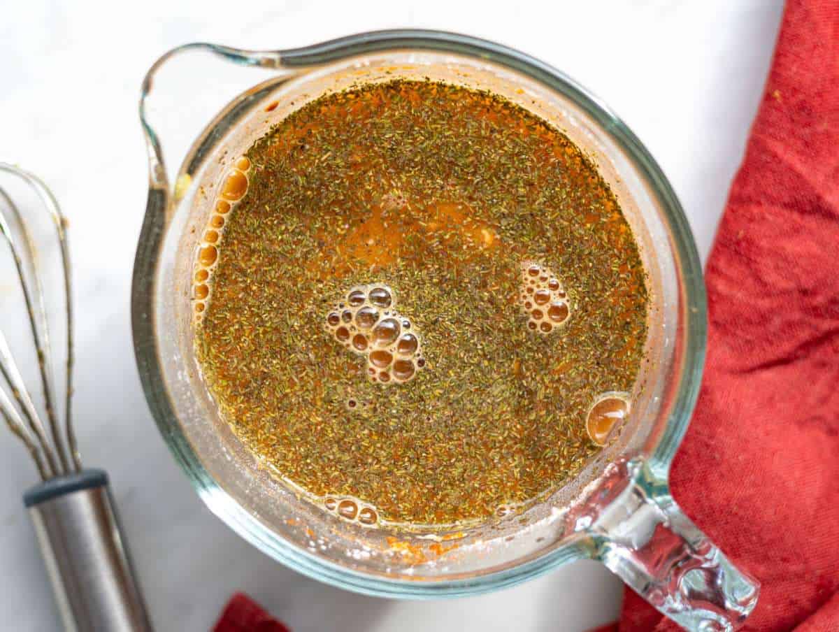 Step 3 Broth and spices whisked together in glass measuring cup.