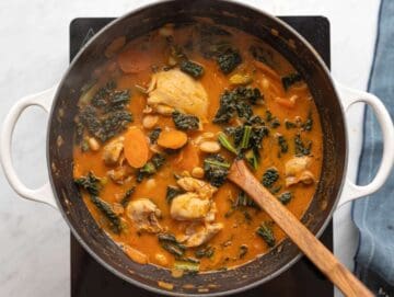 Step 4 Kale and whole white beans stirred into the simmering soup.