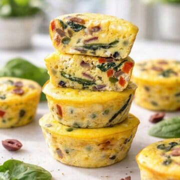 A stack of savory Greek yogurt breakfast egg muffins arranged neatly in bright morning light.