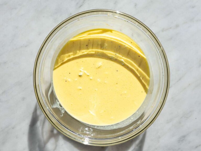 Step 2 A smooth and creamy mixture of whisked eggs and Greek yogurt in a glass bowl.
