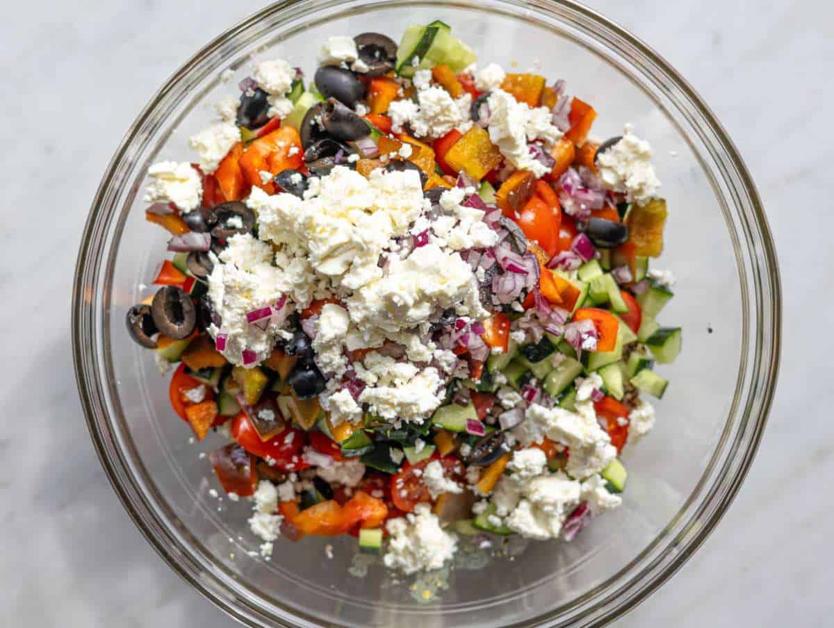 Step 2 Adding quinoa and shredded chicken to bowl with dressing.
