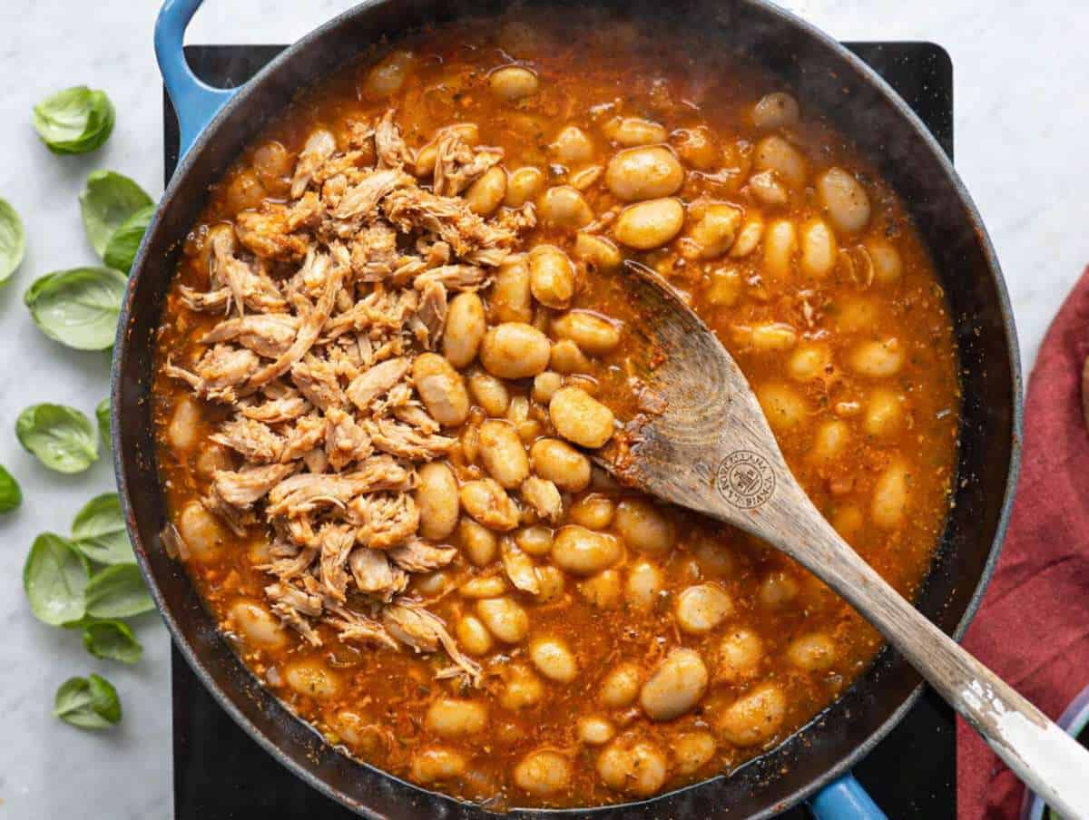Step 2 Butter beans and shredded chicken stirred into rich tomato base in pan.