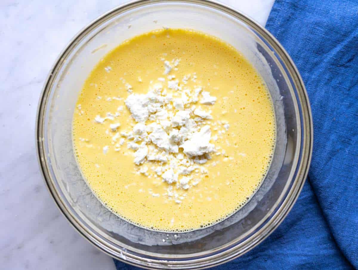 Step 2 Pale yellow eggs, thick Greek yogurt,a nd crumbled feat whisked in a glass bowl.