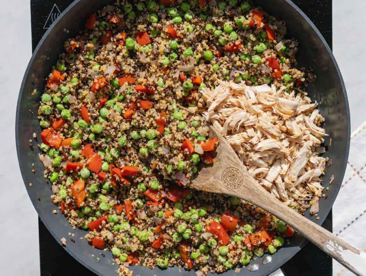 Step 2 Shredded chicken and quinoa spread flat in a pan to create golden, toasted edges.