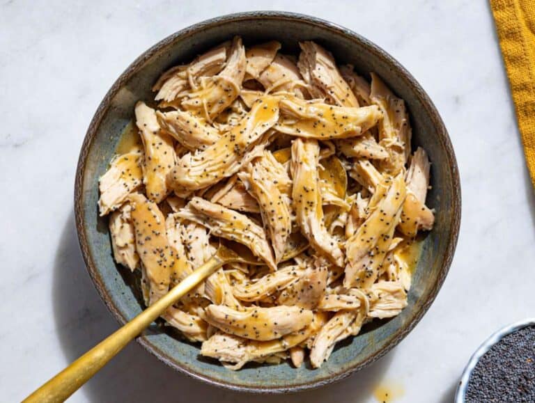 Step 2 Tossing shredded chicken with balsamic dressing in a bowl.