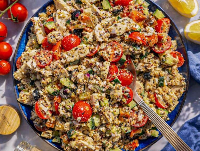 Step 3 Tossing quinoa, chicken, vegetables, and feta and serving it on a platter.