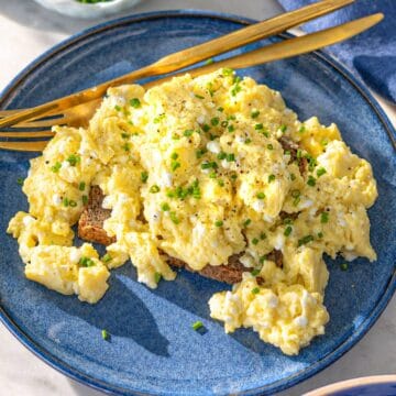 Bright plate of cottage cheese eggs by window light, simple and inviting breakfast.