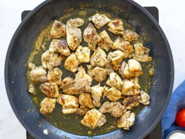 Step 2 Chicken searing in pan with golden edges forming in natural light.